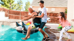Guy pushing old man in the pool